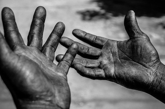 Two hands reaching toward one another.